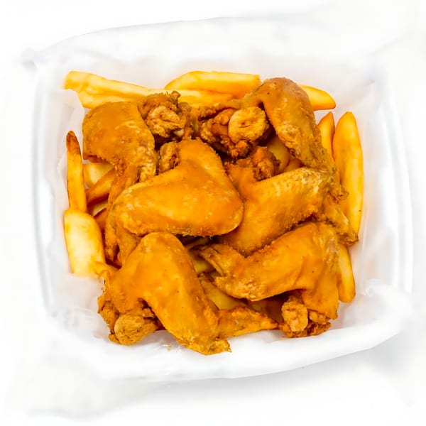 Crispy fried chicken wings and golden french fries in a white takeout container from Sunny's Bar B Que.